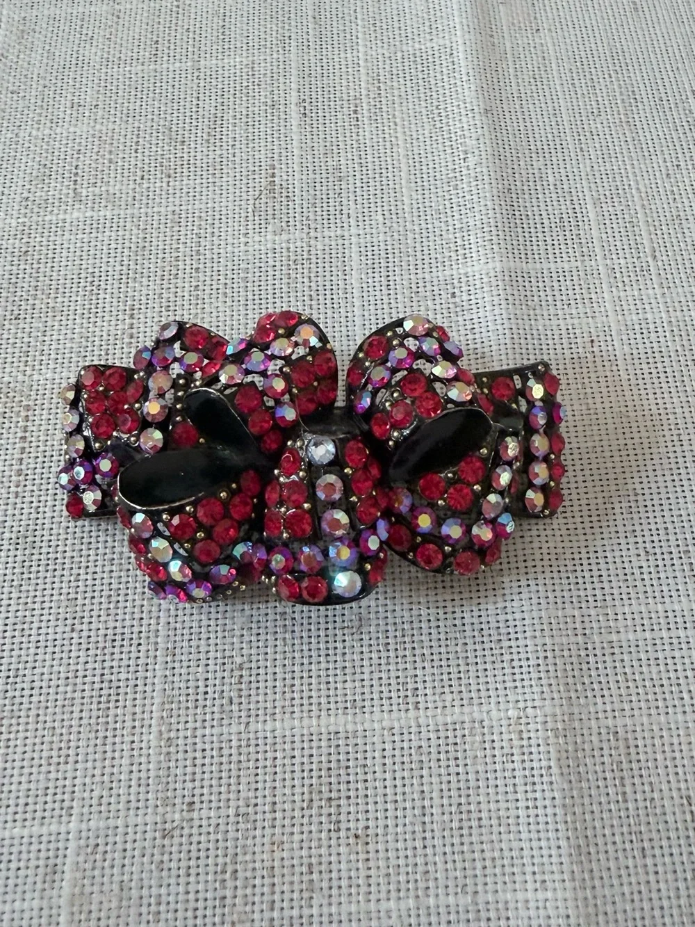 red rhinestone bow hair claw clip embellished with sparkling red and aurora bore